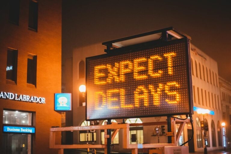 The Deadly Planning Trap Destroying Your Best Timelines 10 Mobile electronic traffic sign with inscription Expect delays placed on road in city street in evening time
