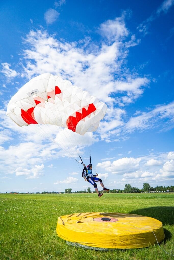 a person in the air with a parachute landing accurately in the target