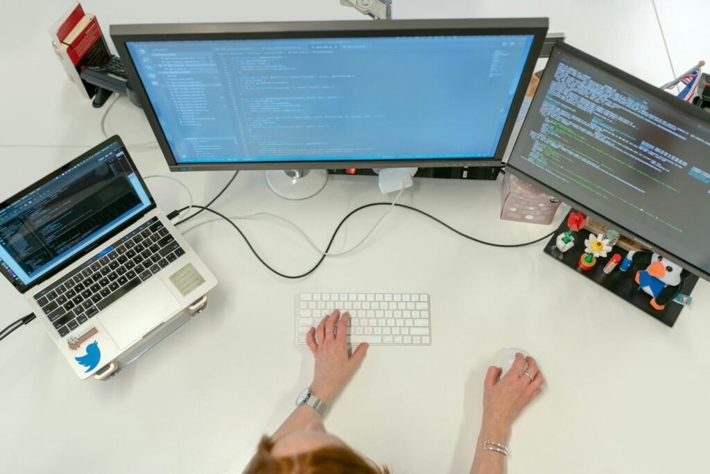 Alt text: AI automation for productivity professional working on multi-monitor setup