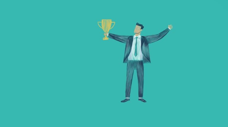 Your Growth Mindset Is Silently Failing Your Leadership Team 7 Man in suit holding a trophy with arms raised