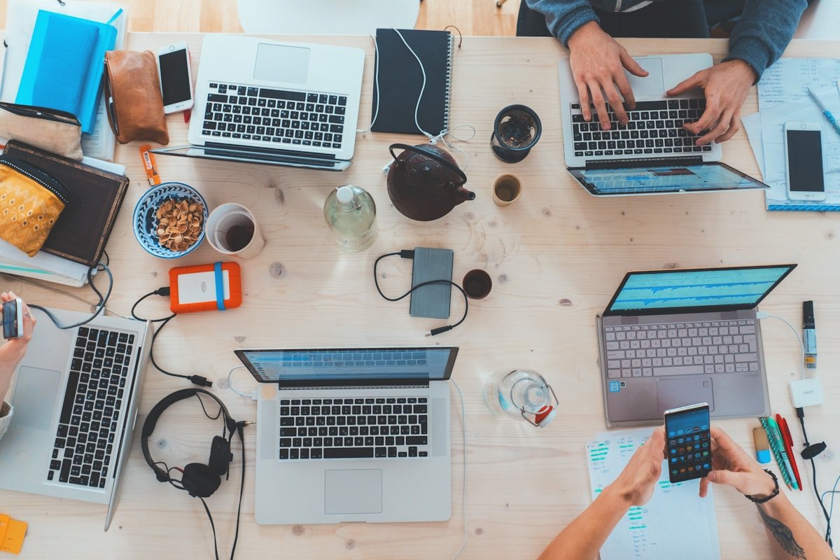 Team collaborating with laptops on an AI consulting decision