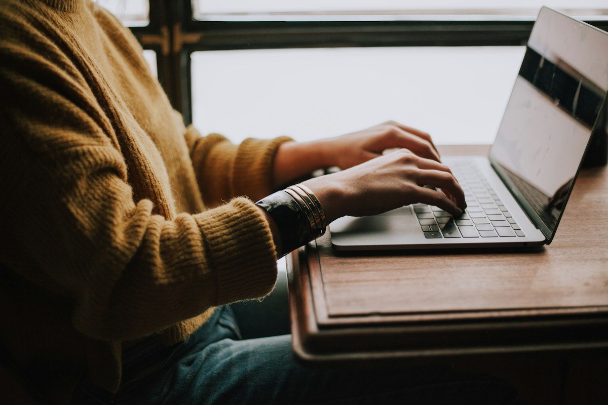 AI Job Search: How to Use AI Without Sounding Like AI 1 Running an AI job search at a laptop, using AI as a thinking partner